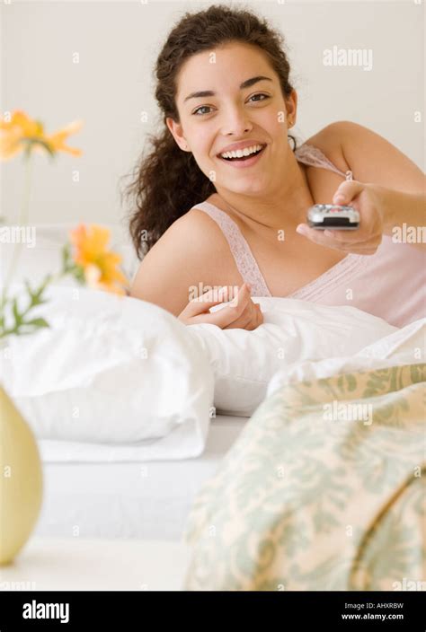 Woman pointing remote control Stock Photo - Alamy