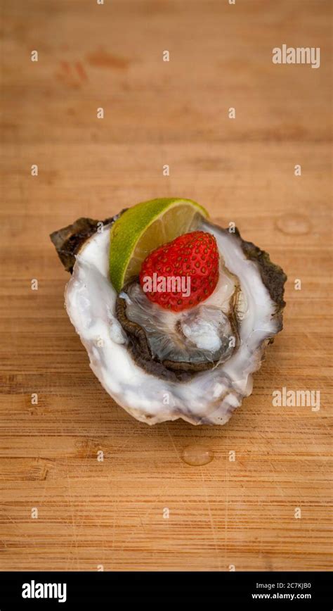 Oyster, raw, delicacy, preparation, lemon, strawberry Stock Photo - Alamy