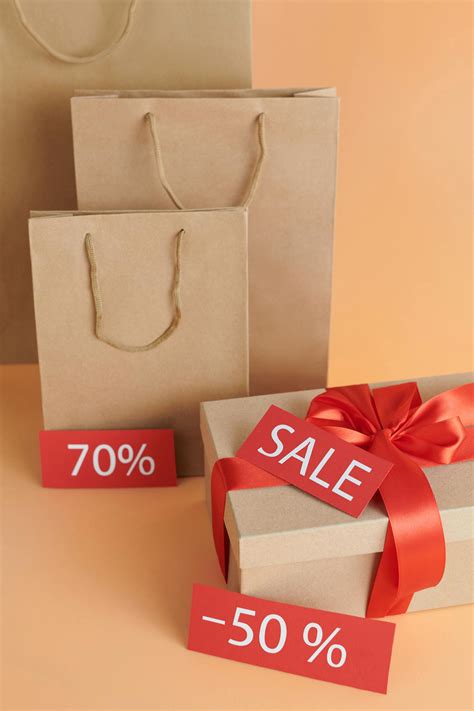 Brown Paper Bags and Cardboard Box with Sale Sign · Free Stock Photo