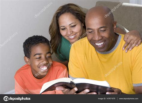 African American multicultural family reading The Bible. Stock Photo by ...