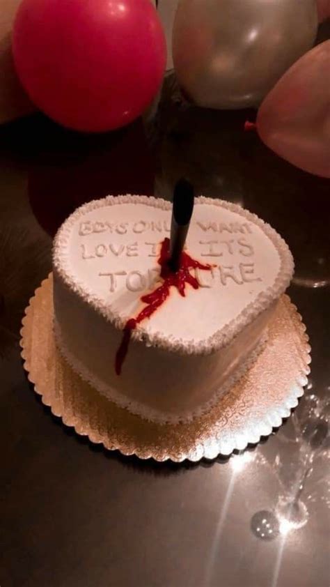 a heart shaped cake with a knife sticking out of it