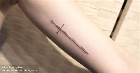 Sword tattoo on the left inner arm.