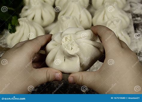 Children`s Hands are Holding Khinkali. Fresh Khinkali with Dough Meat in Flour, a National ...