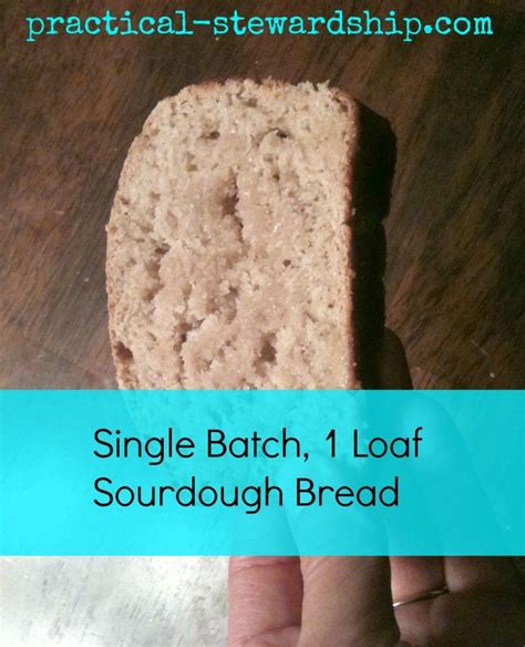 a hand holding a piece of bread on top of a wooden table with the words single batch, 1 loaf ...