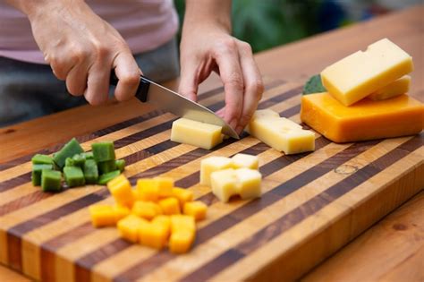 Free Photo | Woman cutting cheese on dices with knife