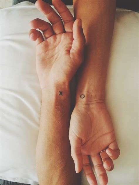 "X" and "O" matching tattoos.