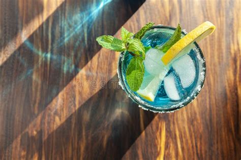 Blue Alcoholic Cocktail in a Glass on a Wooden Bar Counter Stock Photo - Image of cool, drink ...