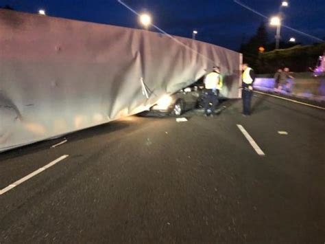 Overturned semi truck lands squarely on top of passing four-wheeler