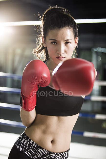 Portrait of female asian boxer — selective focus, backlit - Stock Photo ...