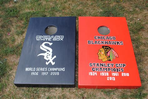two chicago white sox cornhole boards sitting on the grass with their name and team logos