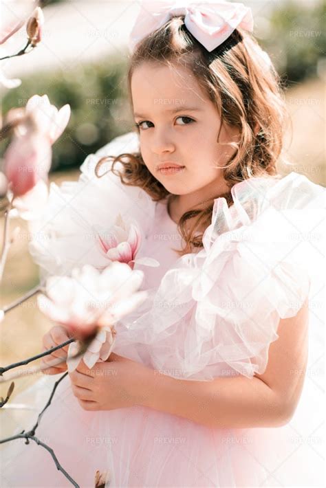 Girl Poses With Flowers Outdoors - Stock Photos | Motion Array