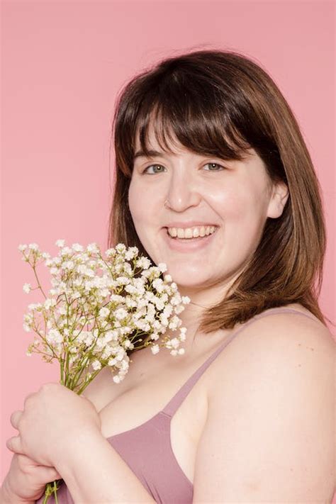 Smiling plus size Asian woman in underwear with small flowers · Free Stock Photo