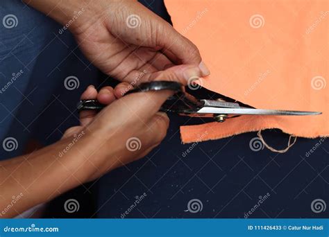 Cutting cloth, version stock image. Image of hands, knife - 111426433