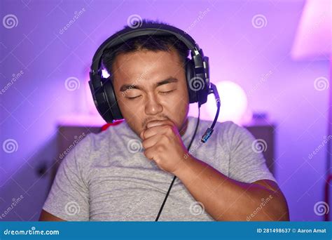 Chinese Young Man Playing Video Games Wearing Headphones Feeling Unwell and Coughing As Symptom ...