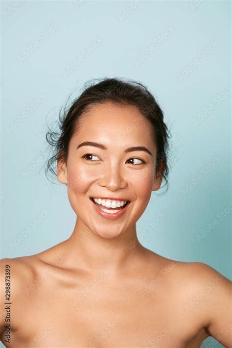 Beauty face. Smiling asian woman with perfect skin portrait. Beautiful happy girl model with ...