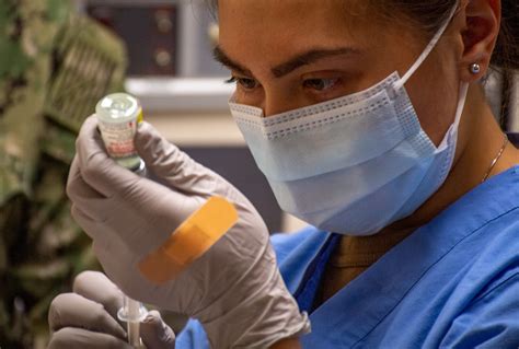 A hospital corpsman prepares a COVID-19 vaccine. | BREMERTON… | Flickr