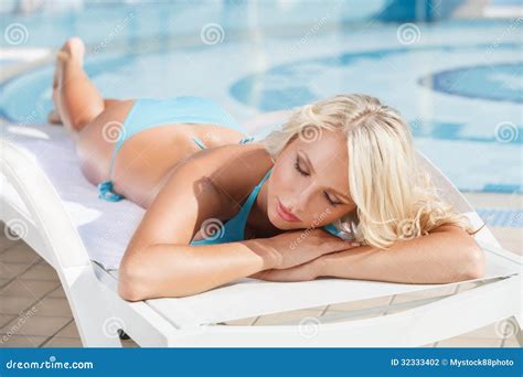 Sun Tanning. Beautiful Young Women In Bikini Lying On The Deck C Stock Photo - Image: 32333402