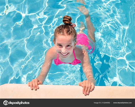 Teen girl in swimming pool squinting her eyes Stock Photo by ©tan4ikk 212244092