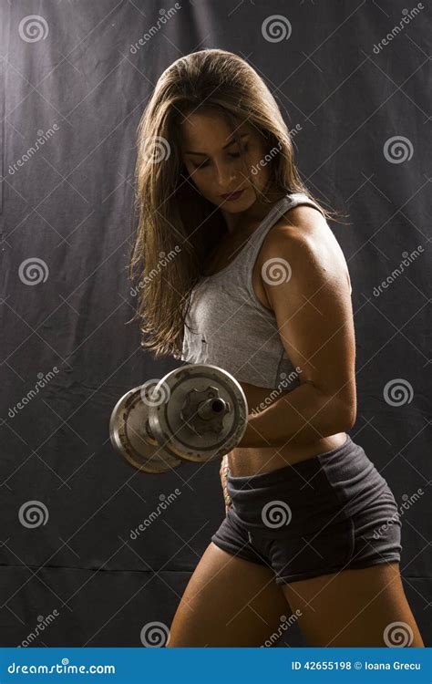 Woman Doing Biceps Curl with Dumbbell Stock Photo - Image of bodybuilding, muscle: 42655198