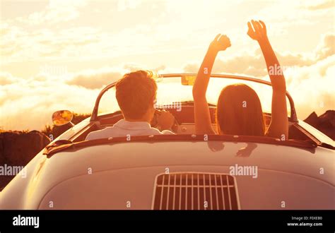 Driving into the Sunset. Happy Young Couple Enjoying the Sunset in ...