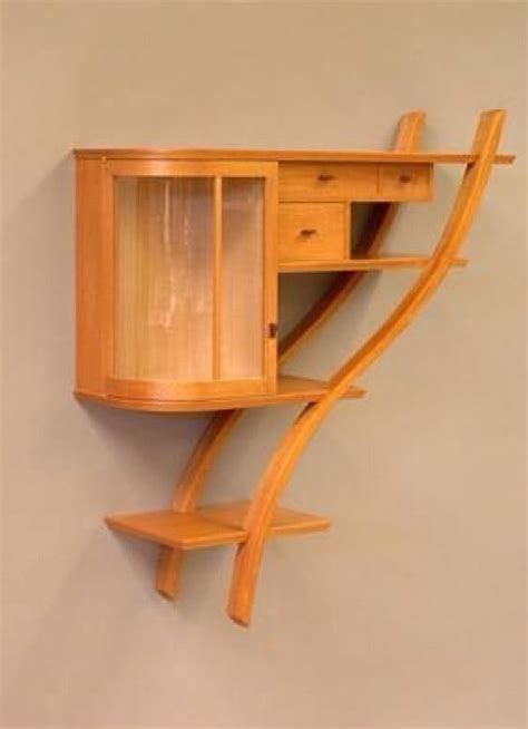 a wooden desk with drawers and shelves on the wall