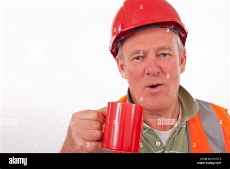 Builder wearing a red hat and drinking tea from a red cup Stock Photo - Alamy