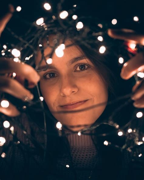 Premium Photo | Young girl preparing christmas lights for the tree