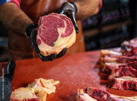 Chef cutting beef steakes in a restaurant Stock Photo | Adobe Stock