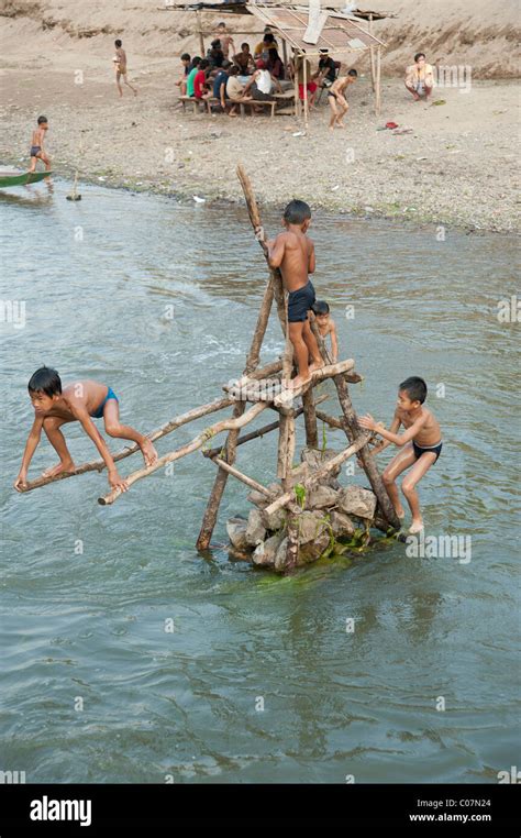 Young Lao boys swimming in a river in Northern Laos Stock Photo - Alamy