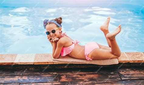 Premium Photo | Barefoot girl lounging near pool