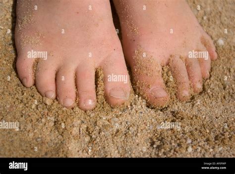 Feet in the sand Stock Photo - Alamy