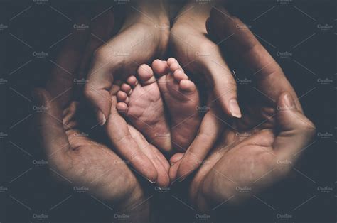 Baby feet in parents' hands 2 ~ People Photos ~ Creative Market
