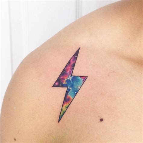 Galactic lightning bolt tattoo on the right shoulder.