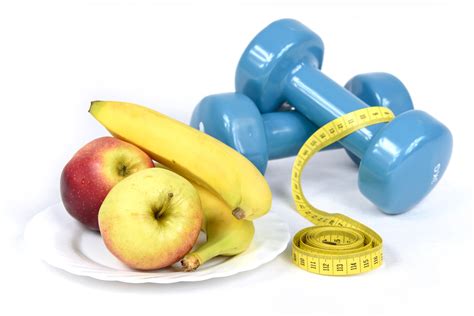 Fitness and Weight Loss Concept. Apples, Dumbbells,Tape Measure, Bananas