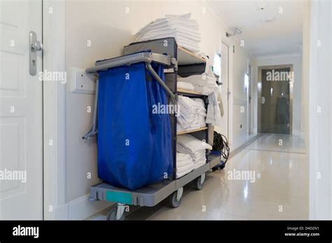 housekeeping cart in bright hotel corridor Stock Photo - Alamy