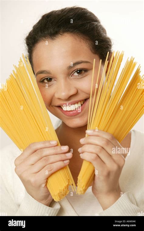 Young girl with spaghetti noodles Stock Photo - Alamy