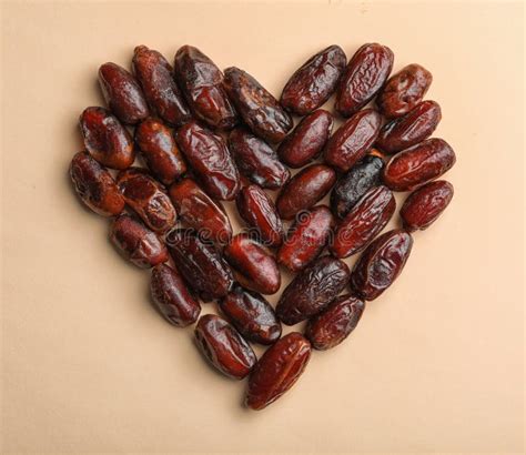 Heart Shaped Pile of Sweet Dried Date Fruits on Color Background, Top View Stock Image - Image ...