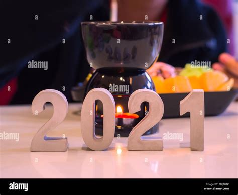 Closeup cement block with number 2021 to Start of New Year plans on lighting candle at shopping ...