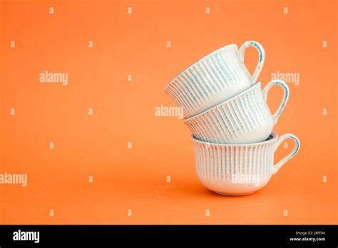Classic white and blue coffee cups on orange background Stock Photo - Alamy