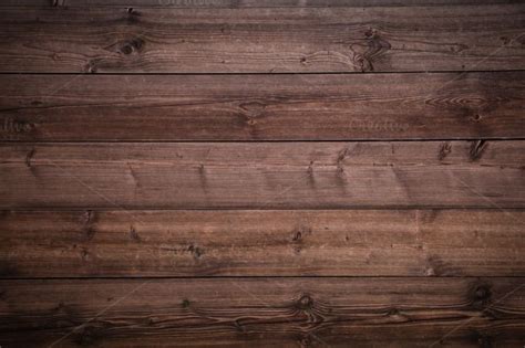 an old wooden wall with knots and nails