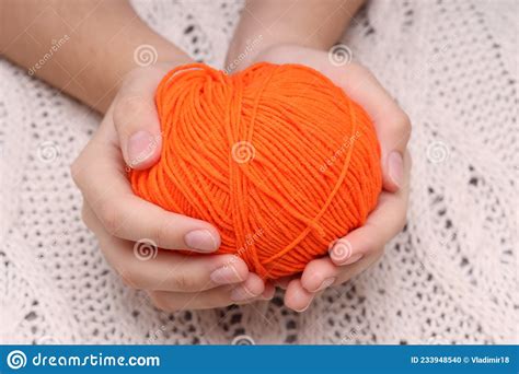 Orange Ball of Wool in Hands on the Background of a White Knitted Tablecloth Stock Photo - Image ...