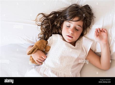 Little girl sleeping in bed Stock Photo - Alamy