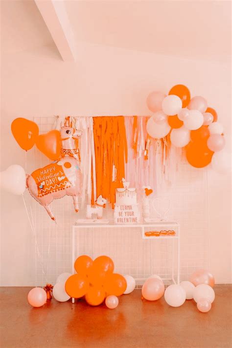an orange and white party with balloons