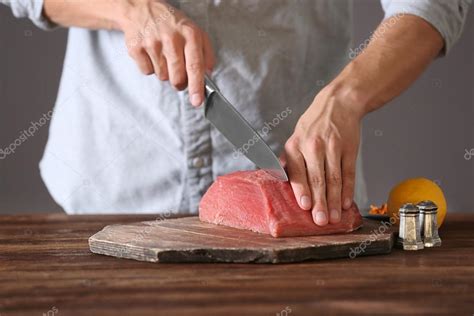 Butcher cutting pork meat Stock Photo by ©belchonock 124107626