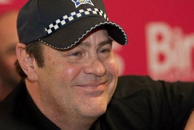 a man wearing a police hat smiling for the camera