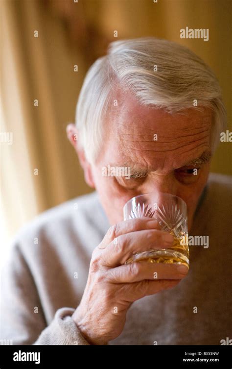 Senior man drinking whiskey Stock Photo - Alamy