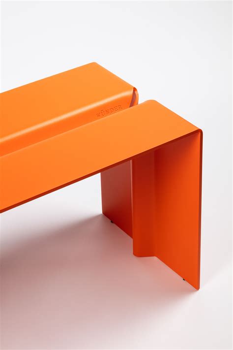 an orange bench sitting on top of a white floor