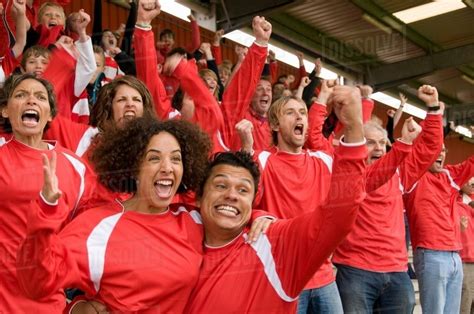 Fans celebrating at at football match - Stock Photo - Dissolve