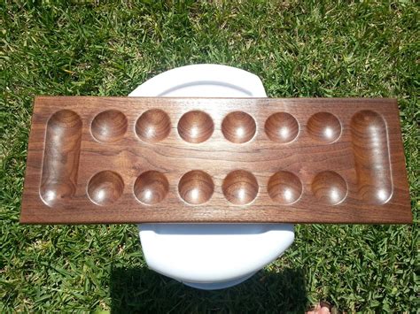 I made a mancala board out of black walnut. Fairly simplistic, but perfect for what I wanted to ...