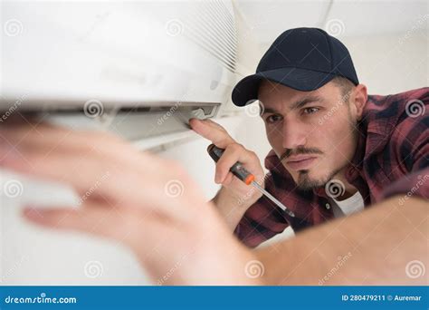 Male Engineer Repairing Wall Mounted Air Conditioning Unit Stock Image ...